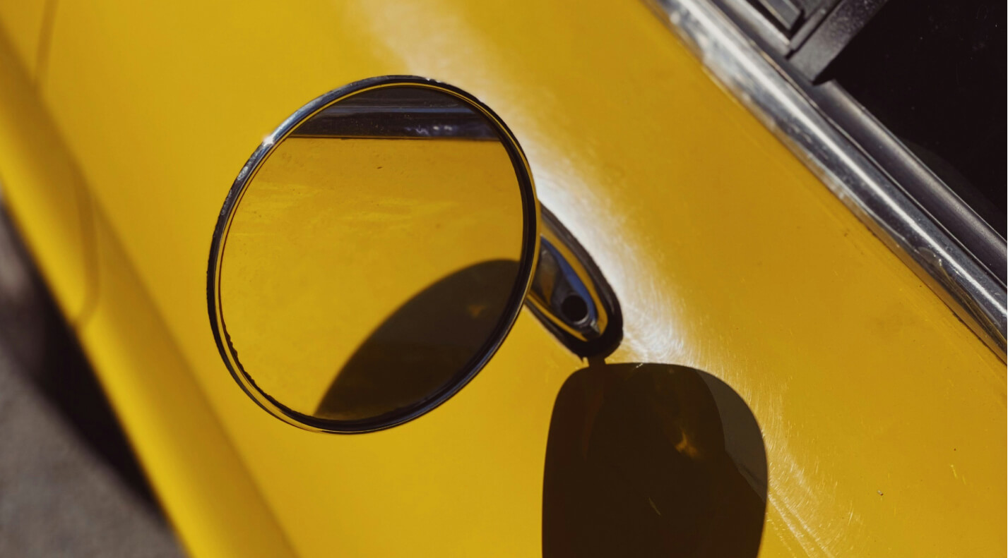 rearview mirror on a yellow car